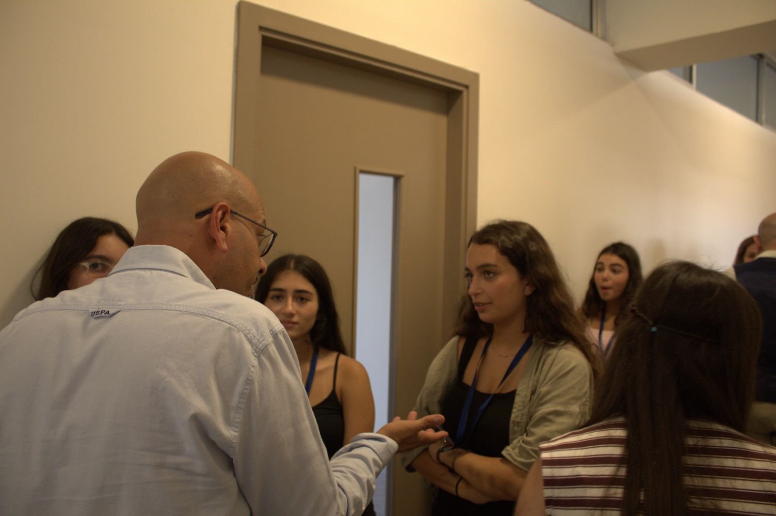 A trainer talking one-on-one with students during the workshop